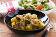 Pork ragout with potatoes and sage and a side salad