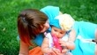 Happy Mother and her baby girl play outdoor