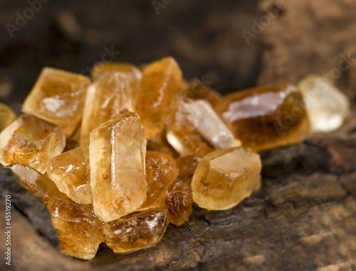 Photo: Brown candided sugar on a wooden surface Brown candided sugar on a wooden surface
