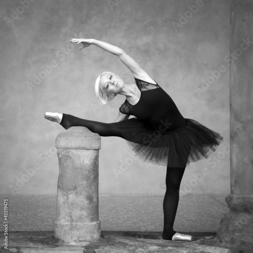 Photo: Young beautiful ballerina dancing out in the street. Young beautiful ballerina dancing out in the street.