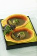 Green tea soup in papaya shells with meat balls (Asia)