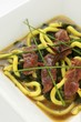 Beef with Japanese mountain pepper, udon noodles and seaweed in vegetable soup