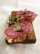 Open sandwiches with salami and capers