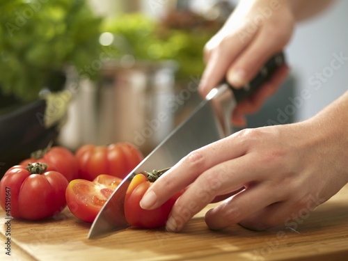 Photo: Tomatoes being halved Tomatoes being halved