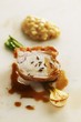 Crispy cochon de lait with caraway risotto and young onions
