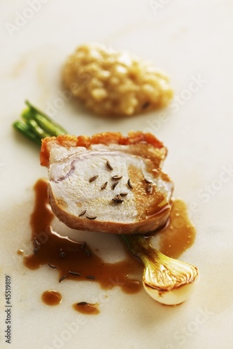 Photo: Crispy cochon de lait with caraway risotto and young onions Crispy cochon de lait with caraway risotto and young onions
