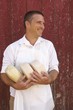 Photo: Cheese Maker in Apron Holding Goat Cheese Rounds Cheese Maker in Apron Holding Goat Cheese Rounds