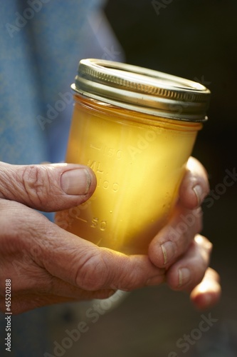 Photo: Hands Holding a Jar of Honey Hands Holding a Jar of Honey