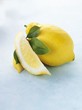 Whole lemon, lemon wedge and leaves