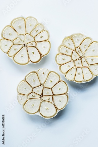 Photo: Three Garlic Bulbs with Tops Sliced Off Three Garlic Bulbs with Tops Sliced Off
