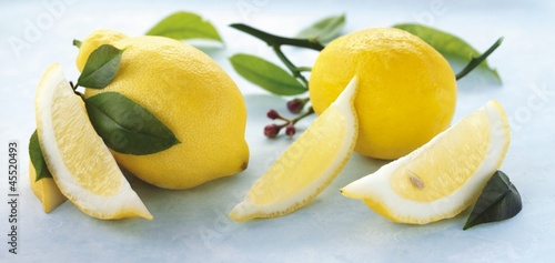 Photo: Whole lemons, lemon wedges and lemon leaves Whole lemons, lemon wedges and lemon leaves