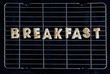 Toast letters spelling the word BREAKFAST on a rack