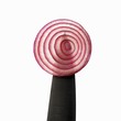 A slice of red onion on a knife