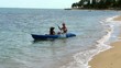 Mother and son kayaking at tropical sea