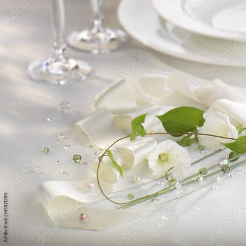 Photo: Elegant table decoration with white bow and flowers Elegant table decoration with white bow and flowers