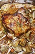 Knuckle of lamb with thyme and vegetables in a roasting tin