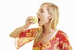 A young woman biting into a green apple