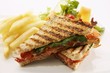Toasted cheese and tomato sandwich with chips and a salad