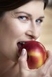 Woman biting into an apple