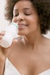 Foto: Young woman drinking milk drink out of a plastic bottle Young woman drinking milk drink out of a plastic bottle