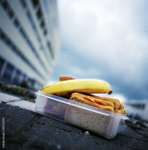 Photo: Lunch box containing cold cut sandwiches and banana Lunch box containing cold cut sandwiches and banana