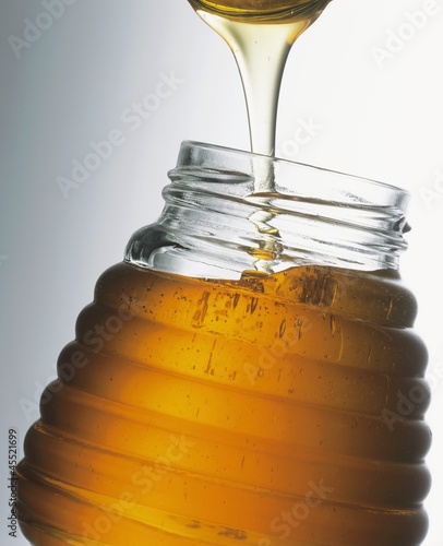 Photo: Honey in jar with spoon Honey in jar with spoon