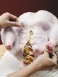 Closing up stuffed turkey with kitchen string