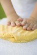 Child's hands kneading dough