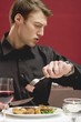 Impatient man eating steak in a restaurant