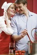Photo: Couple cooking pasta with tomatoes Couple cooking pasta with tomatoes