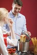 Woman tasting cooked spaghetti