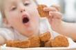 Little girl eating chicken nuggets