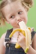 Little girl eating banana