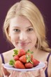 Woman holding a plate of strawberries