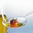 Foto: Cocktail tomato with oil on spoon Cocktail tomato with oil on spoon