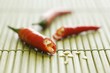 Chilli, cut in half, on bamboo mat