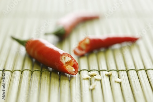 Photo: Chilli, cut in half, on bamboo mat Chilli, cut in half, on bamboo mat