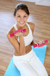 Fitness girl lifting dumbbells in gym