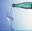 Photo: Water being poured from a bottle into a glass Water being poured from a bottle into a glass