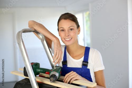 Photo: Cheerful young woman ready to reform house Cheerful young woman ready to reform house