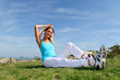 Young woman doing stretching exercises outside