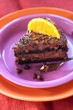 Piece of chocolate mousse cake with a slice of orange