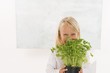 Girl holding a pot of parsley