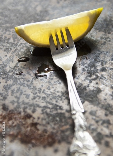 Photo: A lemon wedge on a fork A lemon wedge on a fork