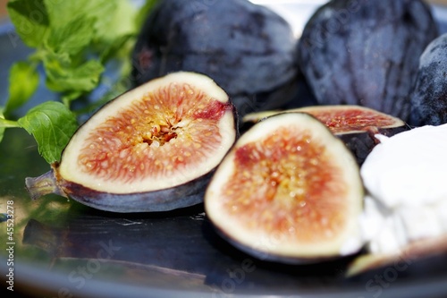 Photo: Fresh Black Mission Figs with Goat Cheese and Mint on a Tray Fresh Black Mission Figs with Goat Cheese and Mint on a Tray
