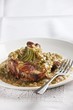 A pork chop with a cucumber and mustard sauce