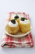 Potatoes topped with cream cheese and caviar