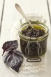 A jar of purple basil pesto