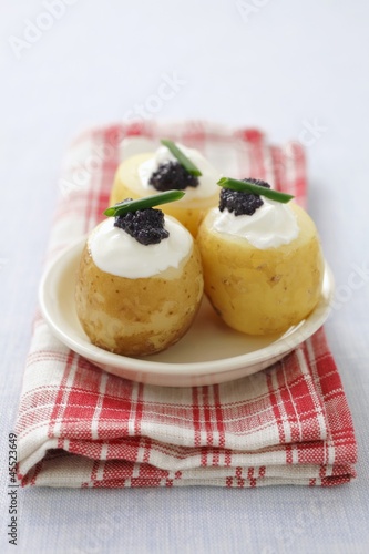 Photo: Potatoes topped with cream cheese and caviar Potatoes topped with cream cheese and caviar