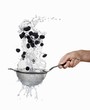 Blackberries being washed in a sieve